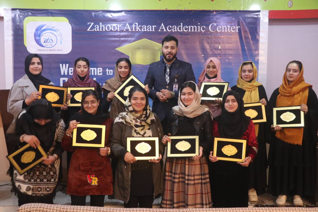 ZAAC female students holding graduation certificates